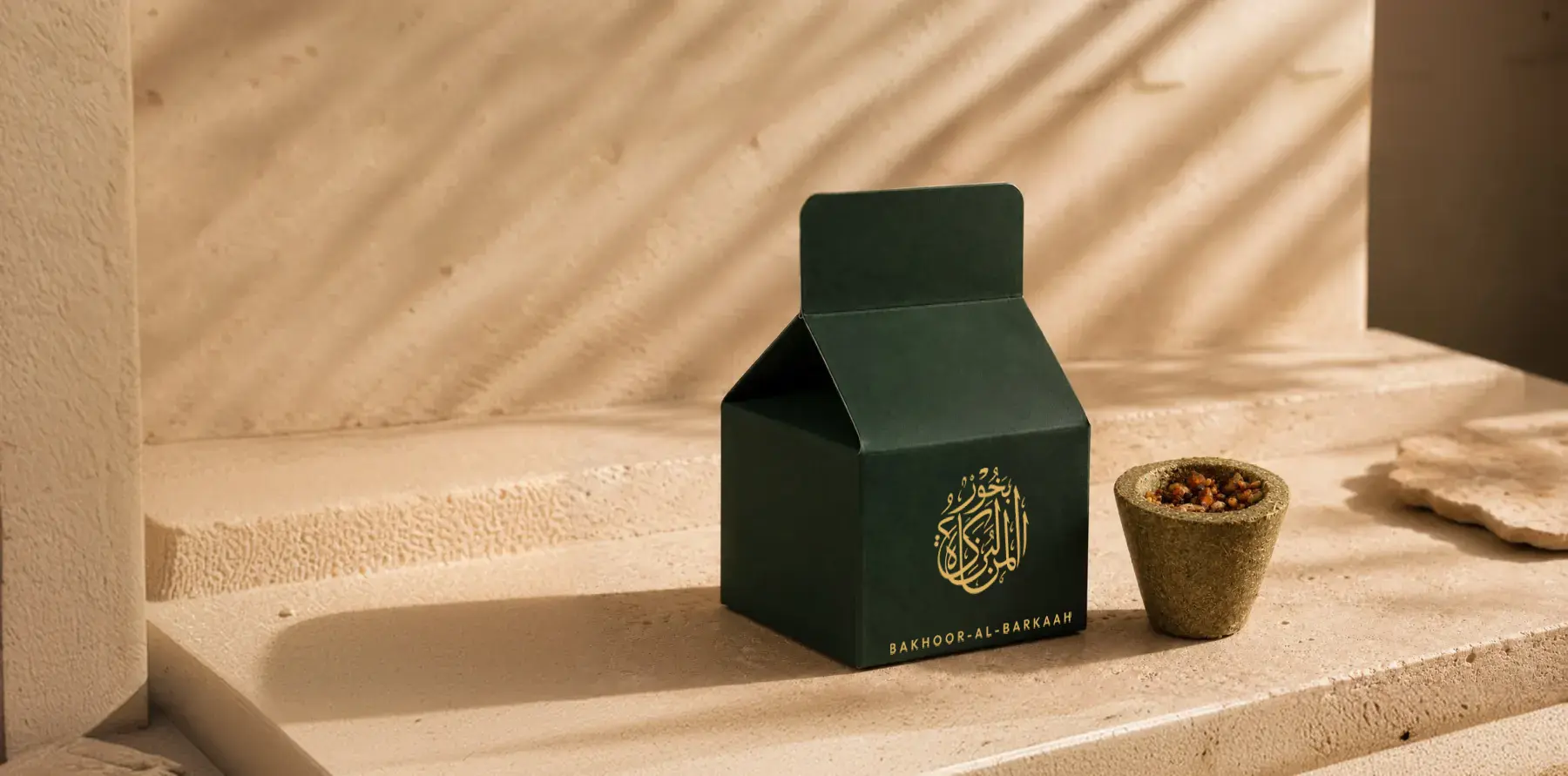 Bakhoor Al Barkaah box beside a smoking resin bowl on stone steps